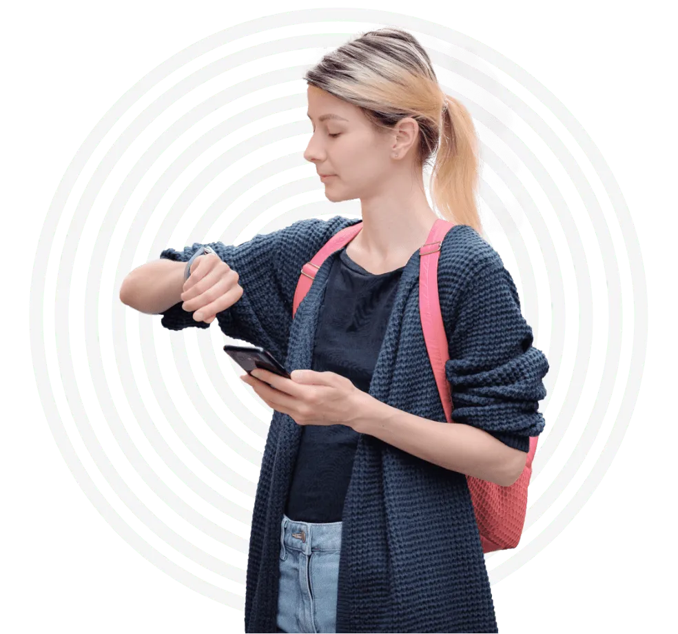 Young woman checking her wristwatch with tuun Resonate waves behind her